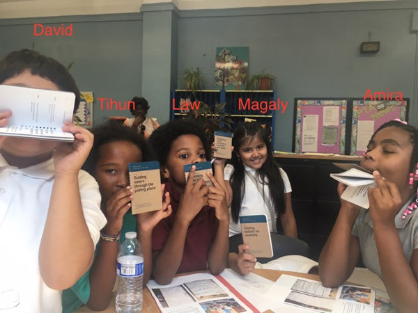 5 young stuents hold up their Field Guides