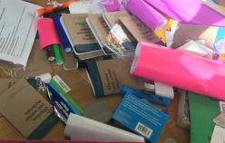 Pile of materials and Field Guides with student names on them