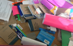 Pile of materials and Field Guides with student names on them