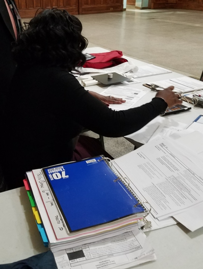 Busy, crowded desk of the polling place captain.