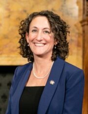 Photo of Kathy Boockvar, a woman with shoulder-length brown hair wearing a blue jacket. 